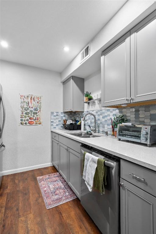 2401 Leon St Unit 208, Austin, TX 78705 - kitchen with visible vents, a toaster, gray cabinets, a sink, and dishwasher
