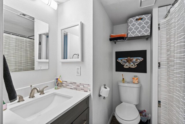 2401 Leon St Unit 208, Austin, TX 78705 - full bath with vanity, backsplash, toilet, and visible vents