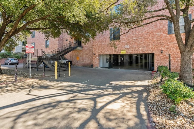 2401 Leon St Unit 208, Austin, TX 78705 - exterior space with an attached garage, driveway, and stairway