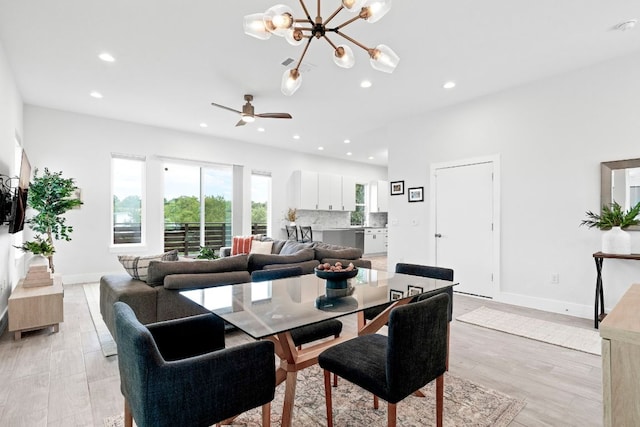 dining area with recessed lighting, visible vents, baseboards, light wood-style floors, and ceiling fan with notable chandelier