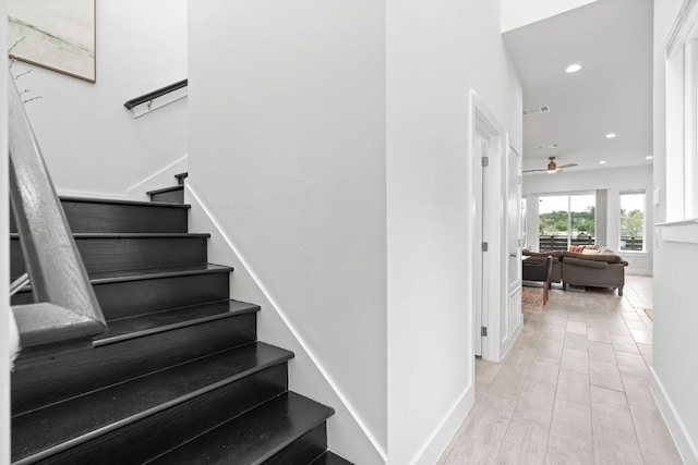 stairway with baseboards, a ceiling fan, and recessed lighting