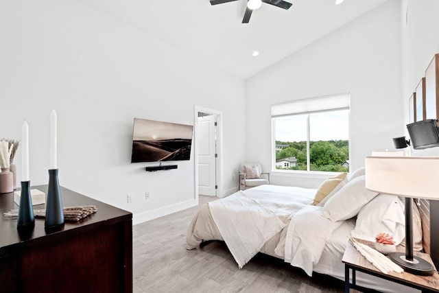 bedroom with baseboards, a ceiling fan, wood finished floors, high vaulted ceiling, and recessed lighting