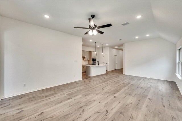 148 Rocky View Ln, Georgetown, TX 78628 - unfurnished living room with ceiling fan, light wood-type flooring, recessed lighting, and vaulted ceiling