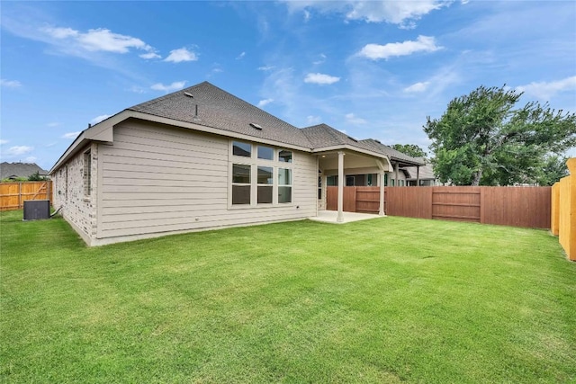 148 Rocky View Ln, Georgetown, TX 78628 - rear view of house featuring a fenced backyard, a patio, and roof with shingles