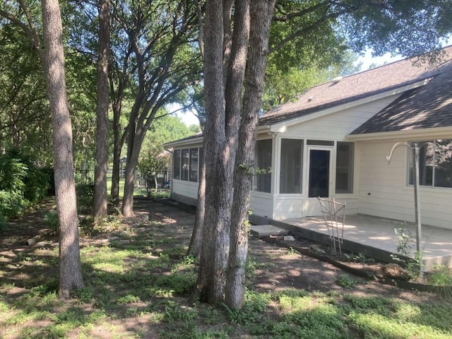 exterior space featuring a sunroom and a patio