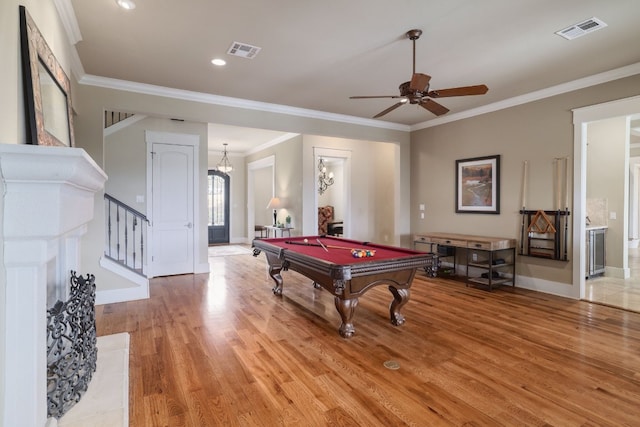 recreation room with light wood-style floors, visible vents, and crown molding