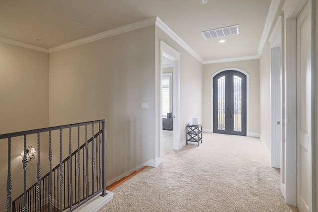 corridor featuring baseboards, visible vents, arched walkways, crown molding, and french doors