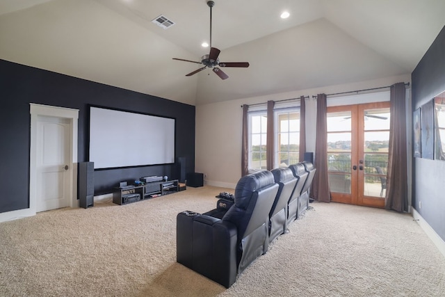 home theater featuring carpet floors, french doors, lofted ceiling, visible vents, and baseboards