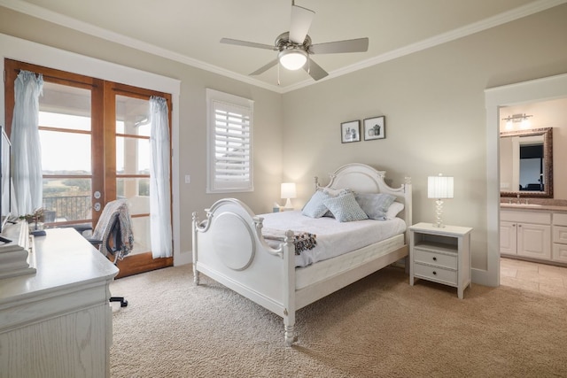 bedroom with ornamental molding, connected bathroom, and light colored carpet