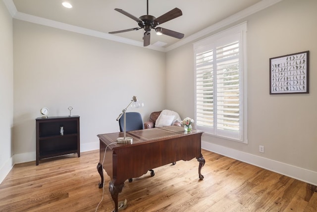 home office with light wood-style floors, baseboards, and ornamental molding