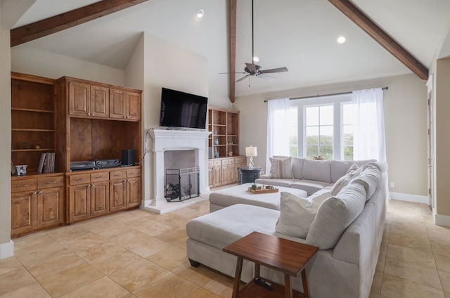 living room with beam ceiling, a fireplace with raised hearth, a ceiling fan, high vaulted ceiling, and baseboards