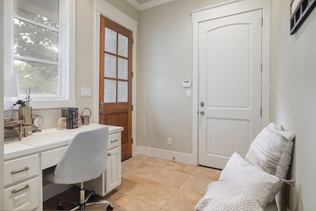 office with light tile patterned floors, built in desk, and baseboards