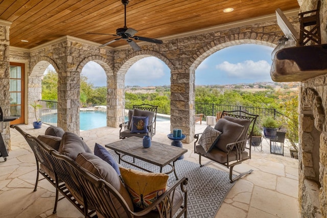 view of patio featuring a ceiling fan, fence, an outdoor living space, and a fenced in pool