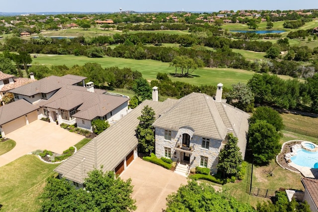 birds eye view of property featuring a water view and view of golf course
