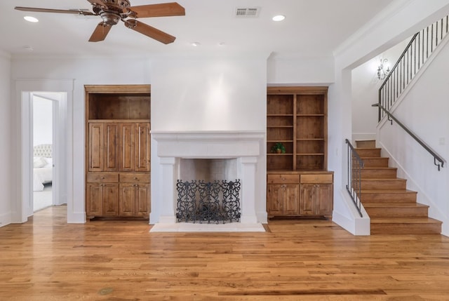 unfurnished living room with ceiling fan, light wood-style floors, recessed lighting, visible vents, and stairway