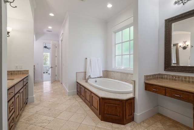 full bathroom featuring vanity, crown molding, a garden tub, and a healthy amount of sunlight