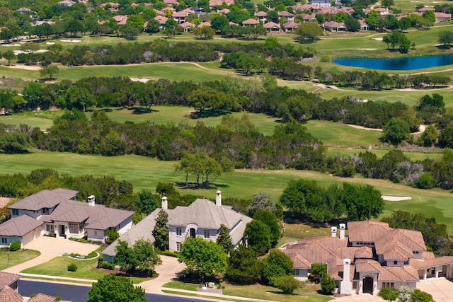 birds eye view of property with a water view and golf course view