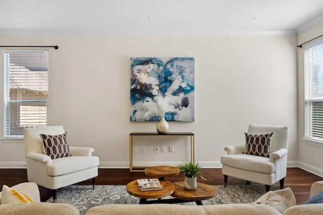 living area with crown molding, baseboards, and wood finished floors