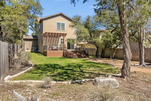 rear view of property featuring a yard, a fenced backyard, a wooden deck, and a pergola