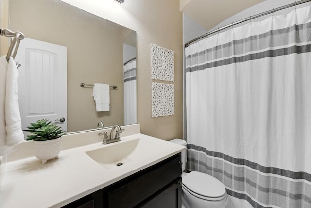 bathroom with toilet, curtained shower, and vanity