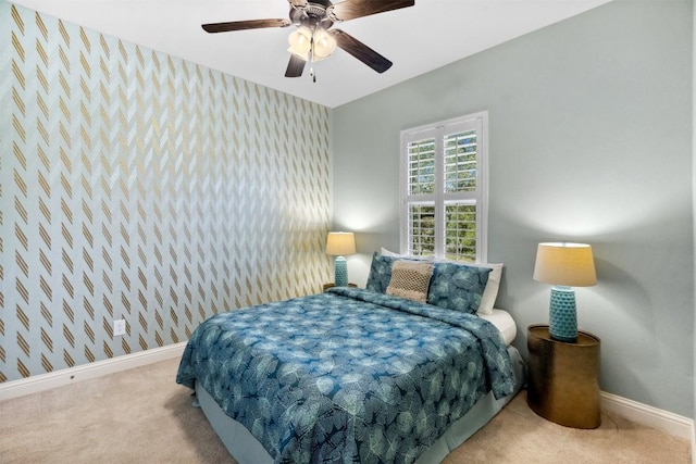 bedroom with baseboards, carpet flooring, a ceiling fan, and wallpapered walls