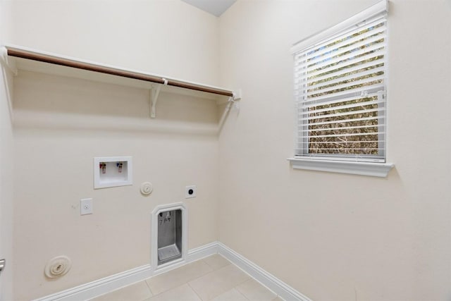 clothes washing area with gas dryer hookup, hookup for an electric dryer, laundry area, washer hookup, and baseboards