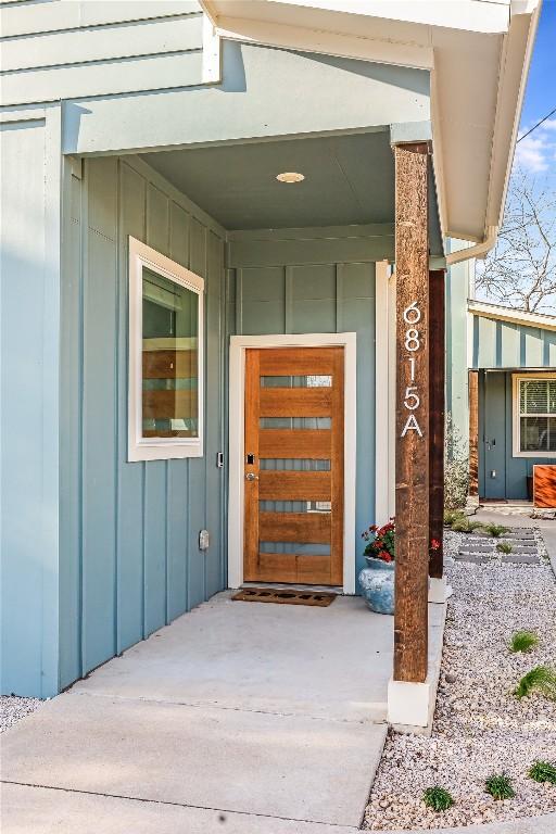 entrance to property featuring board and batten siding