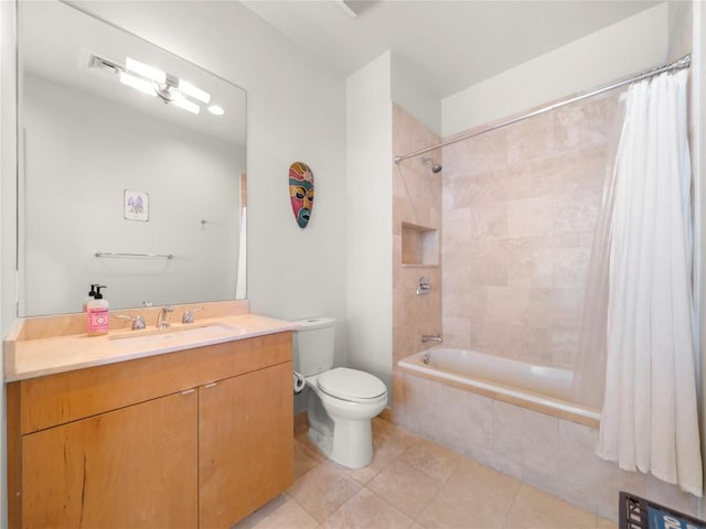 bathroom featuring tile patterned flooring, toilet, tiled shower / bath combo, visible vents, and vanity