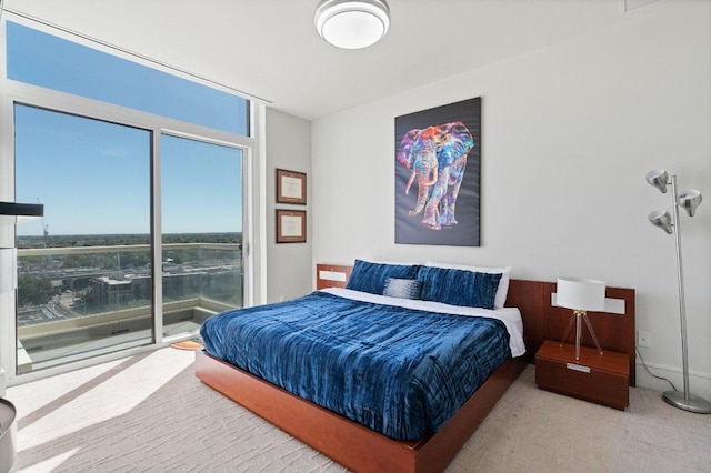 carpeted bedroom featuring access to exterior