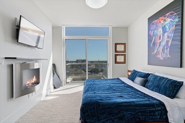 carpeted bedroom with a warm lit fireplace