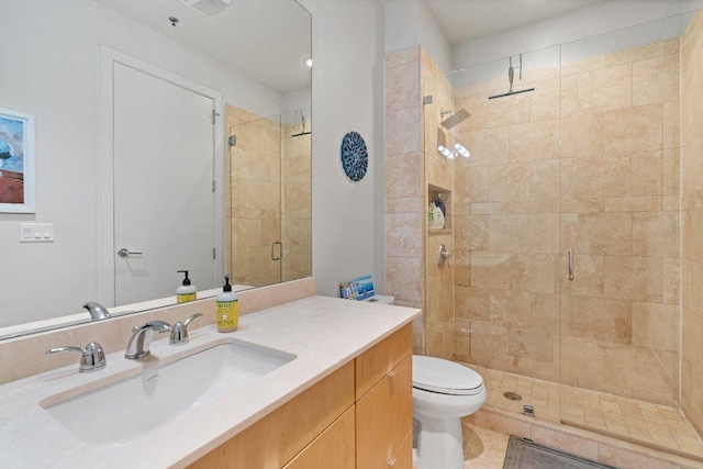 full bath with toilet, a shower stall, tile patterned flooring, and vanity