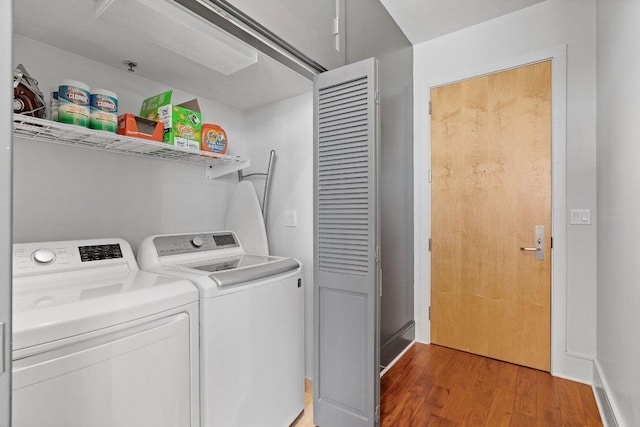 washroom featuring laundry area, light wood finished floors, and washer and clothes dryer