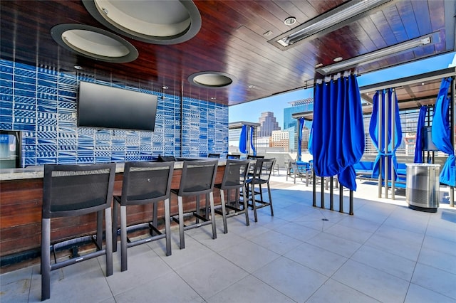 bar with wooden ceiling and tile patterned flooring