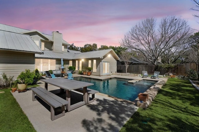 pool at dusk with a patio, fence, a yard, a fenced in pool, and outdoor dining space