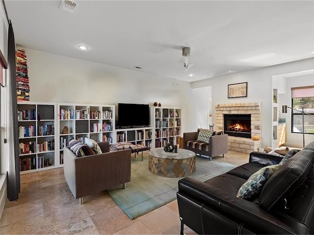 living room with recessed lighting, a fireplace, and visible vents