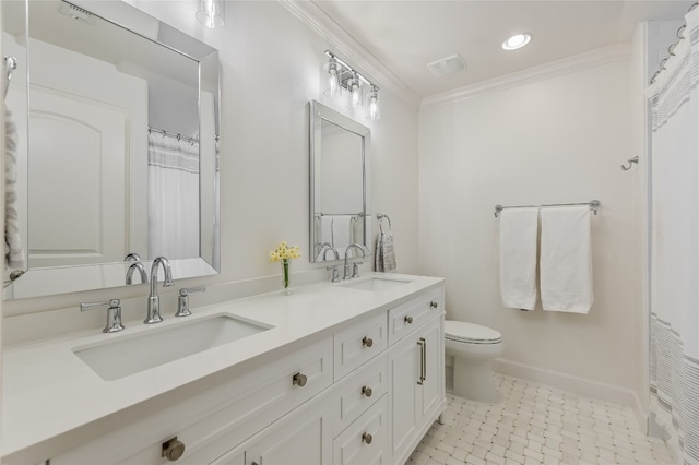 bathroom with double vanity, ornamental molding, a sink, and toilet