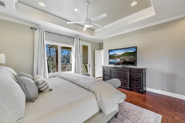 bedroom featuring wood finished floors, access to exterior, baseboards, ornamental molding, and a tray ceiling