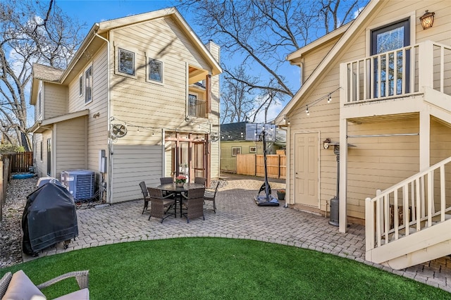 back of property featuring a yard, a patio area, fence, and central AC unit