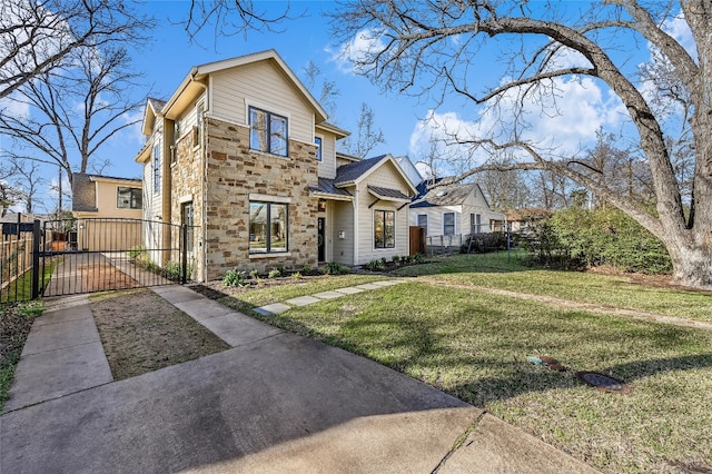 view of front facade featuring stone siding, a front lawn, fence, and a gate