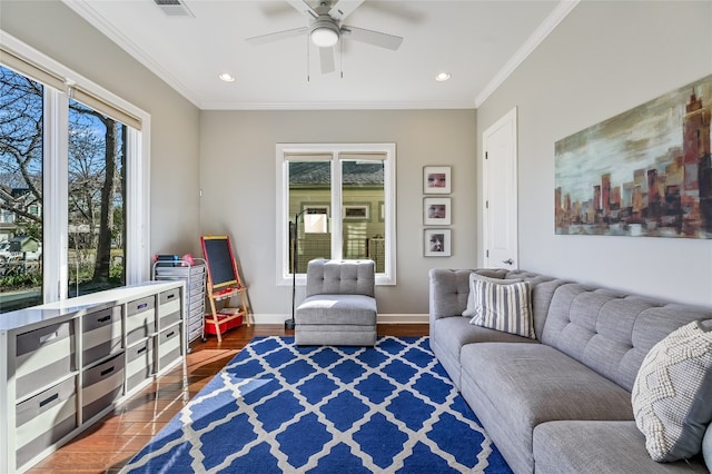 living area with plenty of natural light, ornamental molding, and baseboards