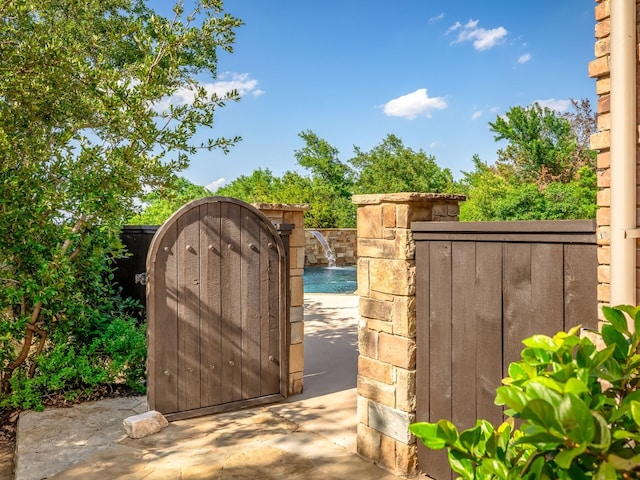 view of gate with fence