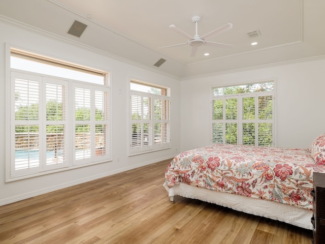 bedroom with recessed lighting, visible vents, light wood-style floors, ornamental molding, and baseboards