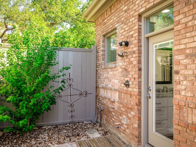 view of exterior entry featuring brick siding