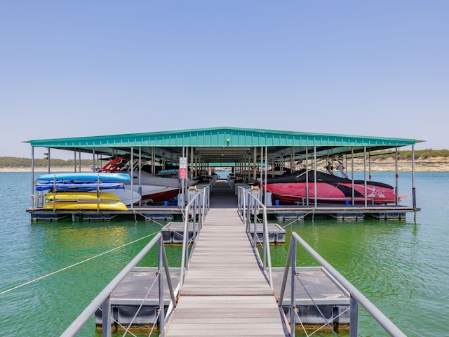 dock area with a water view and boat lift