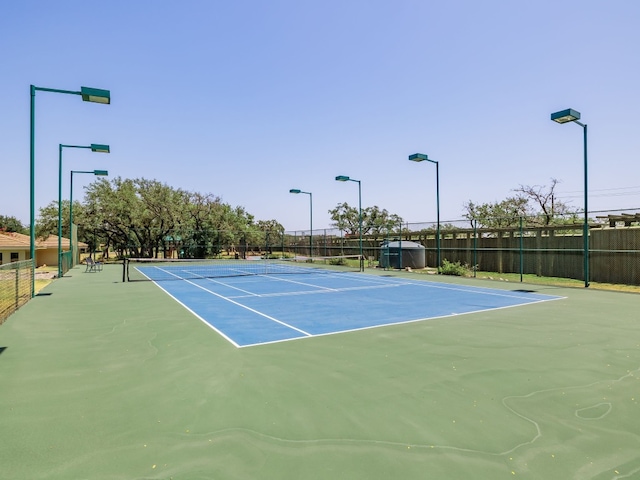 view of sport court featuring fence