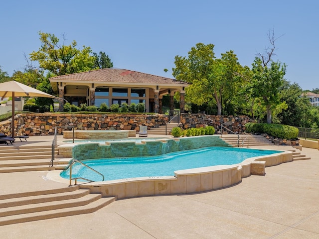 community pool with a patio area