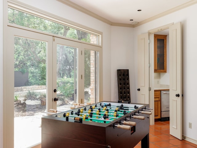 rec room featuring ornamental molding, french doors, and light tile patterned floors