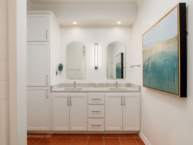 full bathroom featuring double vanity, tile patterned flooring, ornamental molding, and a sink