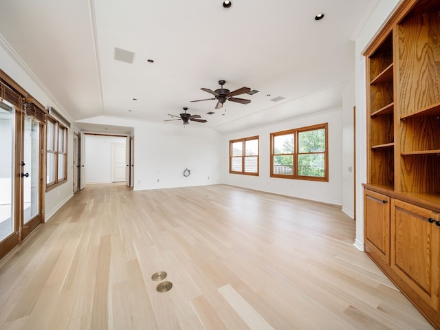 unfurnished living room featuring lofted ceiling, visible vents, baseboards, light wood-style floors, and ornamental molding