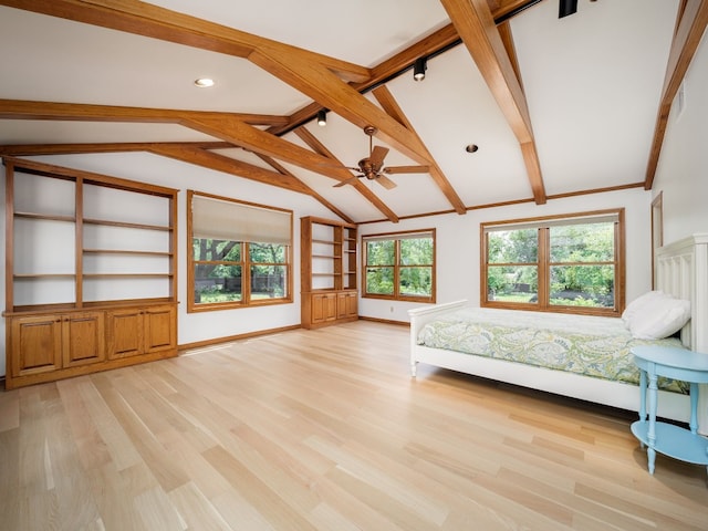 unfurnished bedroom with light wood-style floors, lofted ceiling with beams, and baseboards